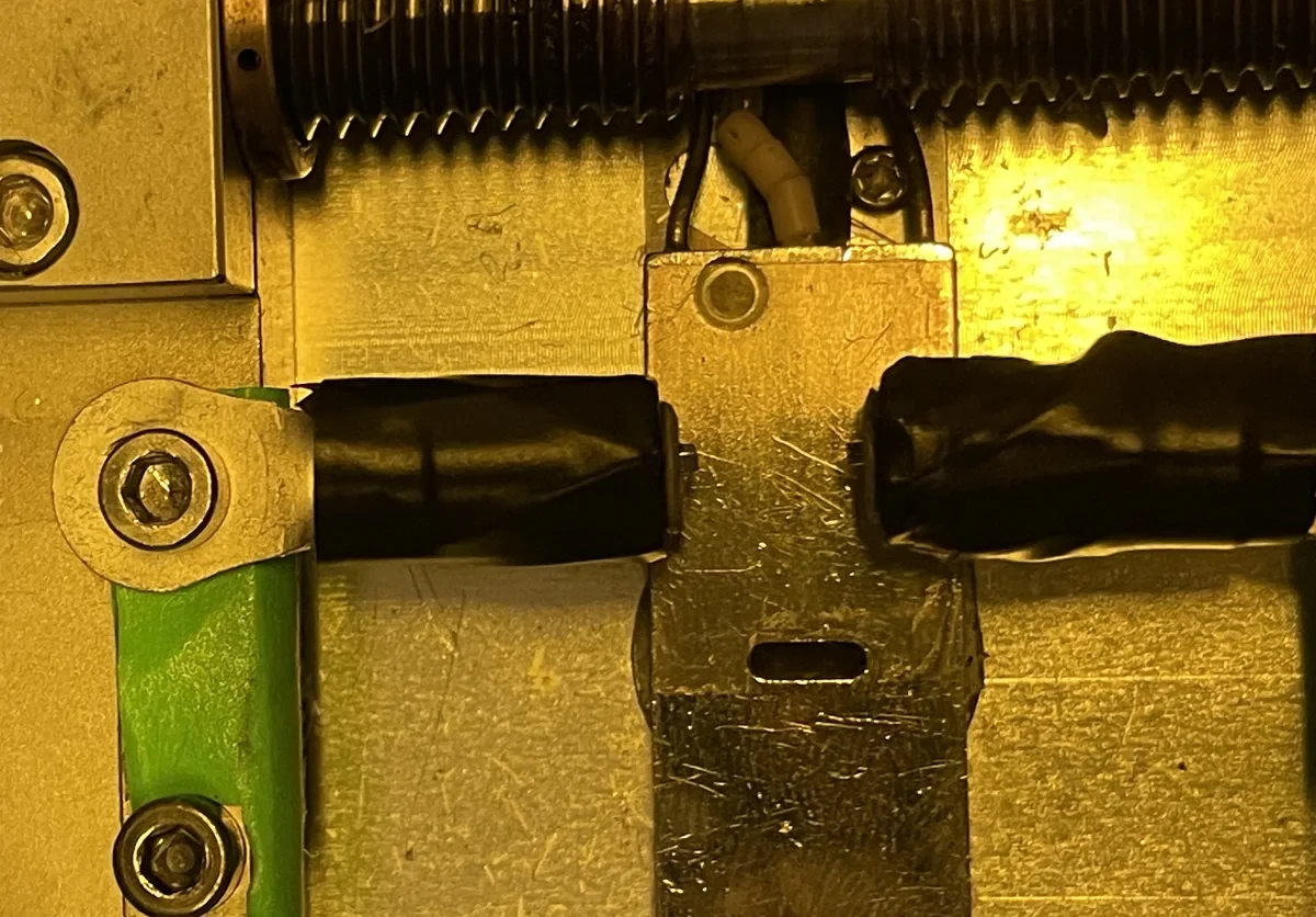 Two taped 1 mm square magnets face to face on the force bench.